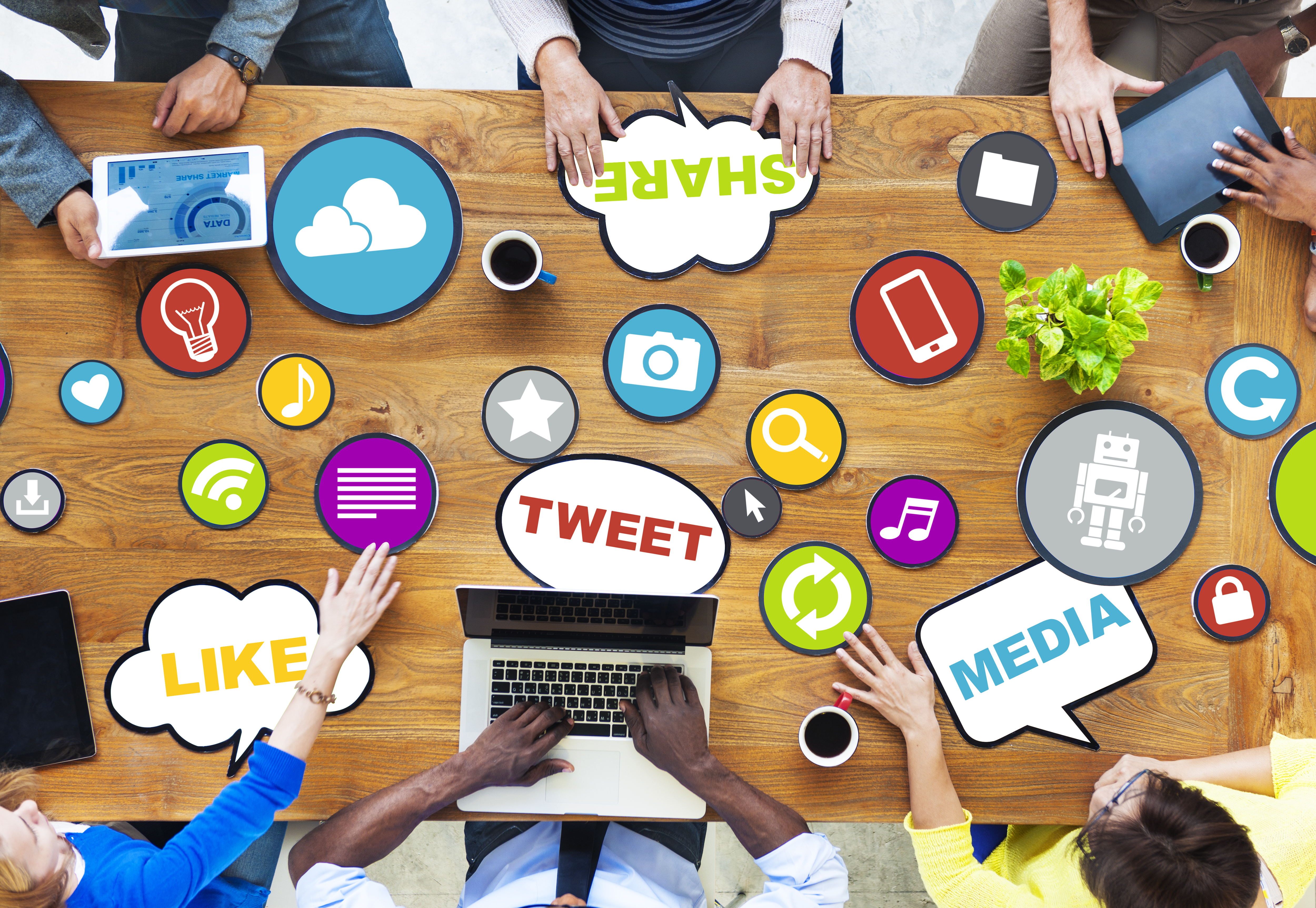 table with people, laptops, icons